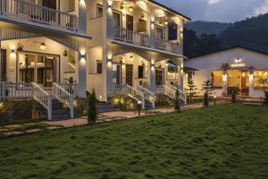 a large white building with a lawn in front of it at PACK Rishikesh, Mohanchatti in Rishīkesh +48 photos