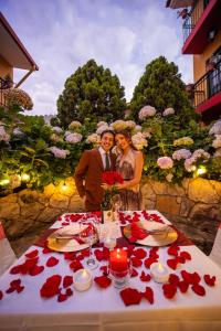 a man and woman standing in front of a table with roses at Hotel Tartar in Cajamarca