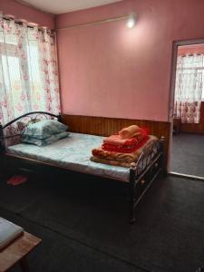 a small bed in a room with a mirror at Bluemoon stay in Darjeeling
