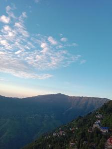 a view of a mountain with a city in the distance at Bluemoon stay in Darjeeling