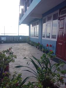 a building with a red door and some plants at Bluemoon stay in Darjeeling +10 photos