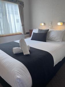 a large bed with two pillows on top of it at Paynesville Holiday Park in Paynesville