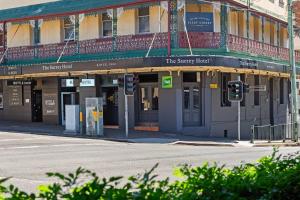 a building on the corner of a street with a traffic light at The Surrey 6 in Sydney