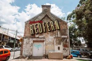 an old brick building with a sign on it at The Surrey 6 in Sydney +4 photos
