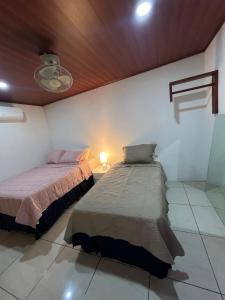 a bedroom with two beds and a ceiling at Hotel Posada Casa Real in León