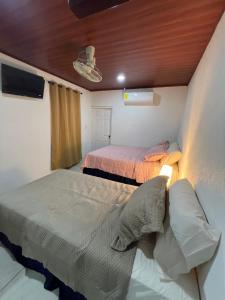 a bedroom with two beds in a room at Hotel Posada Casa Real in León