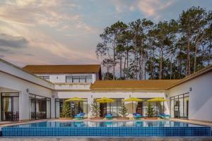 an exterior view of a house with a swimming pool at Lomhae Kirirom Resort by EHM in Phumĭ Péam Lvéa