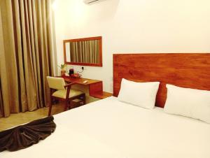 a hotel room with a bed and a desk at Aureva Guest in Weligama