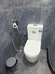 a bathroom with a white toilet in a stall at Aureva Guest in Weligama