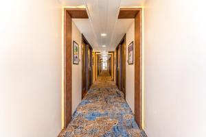 a corridor of a hotel with a long hallway at Treebo Premium Landmark Prayagraj in Prayagraj