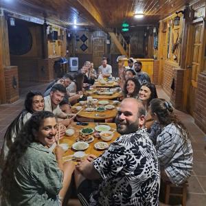 a group of people sitting around a long table at MaMa ShuShu Homestay in Sapa