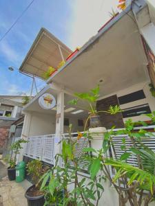 a house with a sign on the side of it at Bandung CoStay in Bandung +35 photos