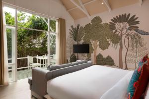 a bedroom with a bed and a large window at Jungle Beach an Uga Experience - Trincomalee in Trincomalee +52 photos