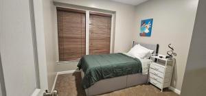 a small bedroom with a bed and a window at Townhome in Ranson, WV in Ranson