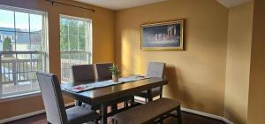 a dining room table with chairs and a picture on the wall at Townhome in Ranson, WV in Ranson +6 photos