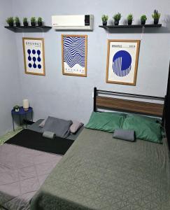 a bedroom with two beds and posters on the wall at Departamento Completo en el Centro de Monterrey in Monterrey