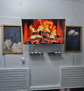 a tv hanging on a wall with a fire at Departamento Completo en el Centro de Monterrey in Monterrey +1 photo