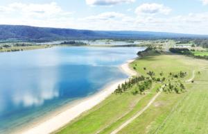 an aerial view of a beach and the ocean at KozyGuru | Penrith | Spacious Ground Floor Gem in Penrith