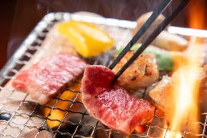 a basket of food with meat and fruit on it at Bessou Konjakuan in Yufu