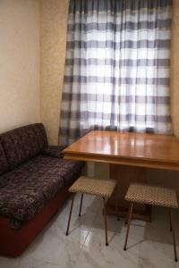 a couch and a table in a room with a window at ApartHotel EURO in Cahul +2 photos