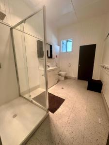 a bathroom with a shower and a toilet at Western Hotel in Mitchell