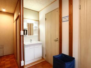 a bathroom with a sink and a mirror at Guesthouse&Café Deep in Kōzushima