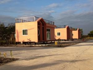 a row of modular homes on the side of a road at 7 Rooms resort in Ban Tamyae