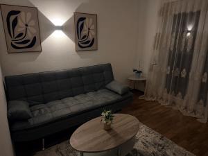 a living room with a couch and a table at Apartment Dolina 8a Kärnten KLagenfurt in Dolina