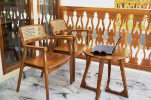 a wooden chair and a laptop on a table at Salili Resort in Gili Islands