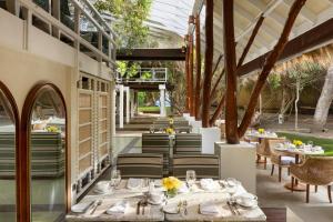 an outdoor dining area with tables and chairs at Jungle Beach an Uga Experience - Trincomalee in Trincomalee