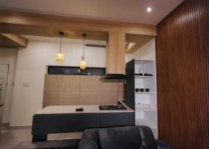 a living room with a couch and a kitchen at G' de CASA in Varkala