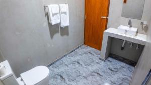 a bathroom with a marble floor and a toilet and sink at Dana Villa in Bentota +25 photos