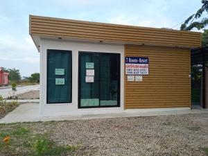 a building with a sign on the side of it at 7 Rooms resort in Ban Tamyae