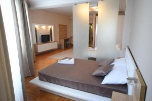 Llit o llits en una habitació de Garni Uni Elita Lux Hotel