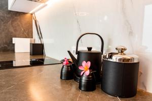 a couple of black tea pots sitting on a counter at Anoya Boutique Villa in Kerobokan
