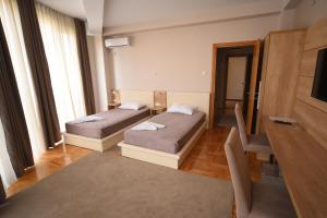 Llit o llits en una habitació de Garni Uni Elita Lux Hotel