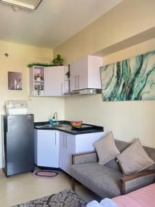 a kitchen with a couch and a sink and a counter at Avida Tower 2 in Davao City
