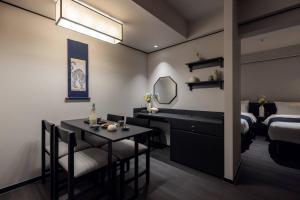 a bedroom with a bed and a table with a mirror at Hotel Jak Insadong by Anook in Seoul