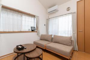 a living room with a couch and a table at Suncity Hakata in Hakata