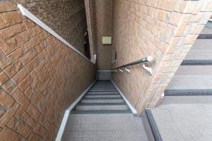 a stairway in a building with a brick wall at Suncity Hakata in Hakata