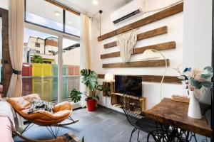 a living room with a fireplace and a table and chairs at StayX Central Suites Q1 in Ho Chi Minh City