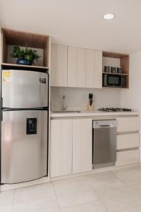a kitchen with a stainless steel refrigerator and cabinets at Casa G, en Rionegro in Rionegro +54 photos