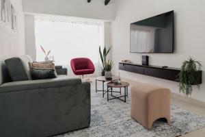 a living room with a couch and a red chair at Casa G, en Rionegro in Rionegro