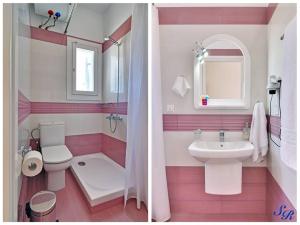 a pink and white bathroom with a toilet and a sink at Sarakiniko Rooms in Adamantas