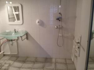 a bathroom with a shower and a sink at Hôtel Land'Azur in Mimizan-Plage