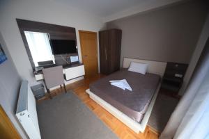 Llit o llits en una habitació de Garni Uni Elita Lux Hotel