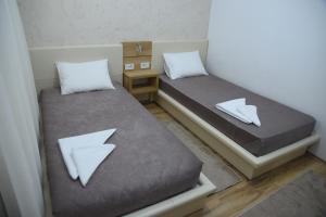 Llit o llits en una habitació de Garni Uni Elita Lux Hotel