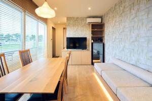 a living room with a table and a couch at Long Vacation Resort in Fukuoka +48 photos