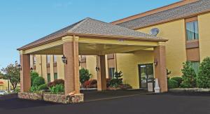 a hotel building with a large gazebo at Days Inn & Suites by Wyndham Bloomington/Normal IL in Bloomington