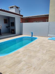 a swimming pool in the backyard of a house at House with pool Arroio do Sal in Arroio do Sal